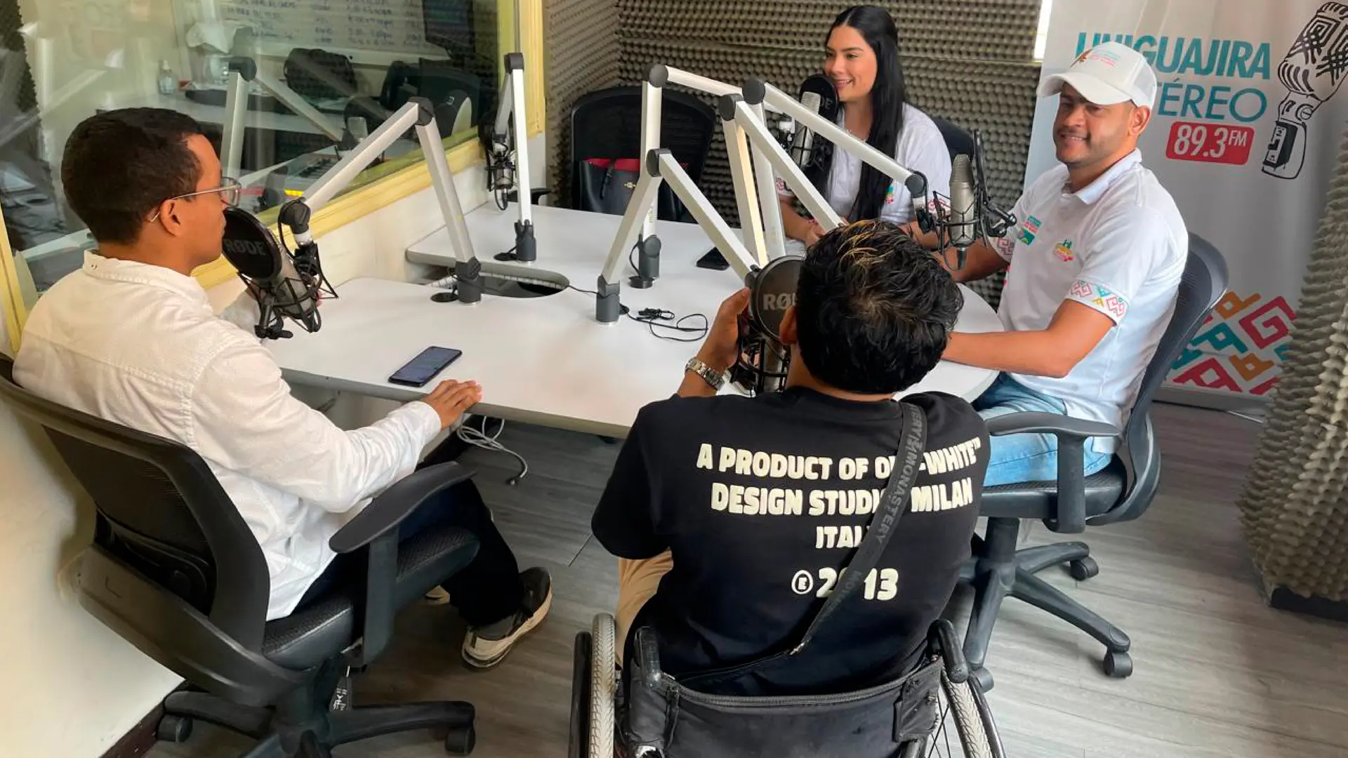 cuatro personas adultas tres hombres y una mujer en los estudios de la emisora de Uniguajira